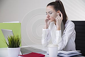 Manager with headphones in her office