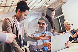 Manager helping senior worker with computer work in office, mentor teacher training, happy older employee at