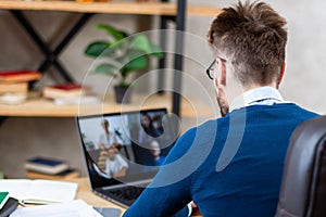 Manager holding video conference with colleagues