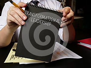 Manager holds info about Transformational leadership. photo