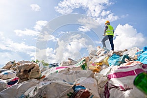 A manager holds a tablet on top of a pile of recycling bottles at recycling plant. Recycle waste business concept. Recycle waste