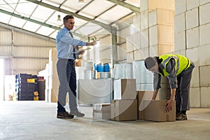 Manager instructing female worker while working