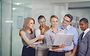 Manager with laptop showing, training or presenting strategy ideas or brainstorm plans with diverse group of office