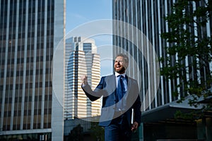 Manager in a luxury modern open space business center. Successful business man outside.