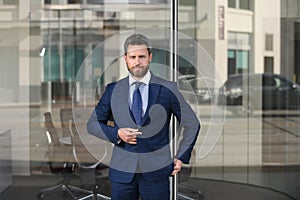 Manager in a luxury modern open space business center. Successful business man outside.