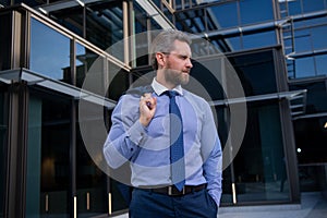 Manager in a luxury modern open space business center. Successful business man outside.