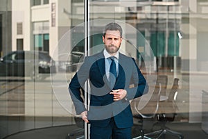 Manager in a luxury modern open space business center. Successful business man outside.