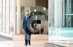 Manager in a luxury modern open space business center. Successful business man outside.