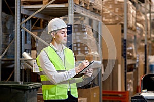 Manager man worker doing stocktaking of product management on shelves in warehouse