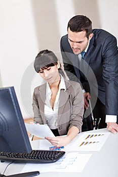Manager overseeing business woman photo