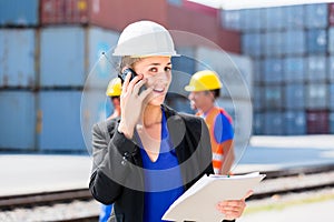 Manager with phone talking on shipment yard
