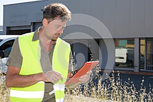 manager showing tablet pc front large warehouse