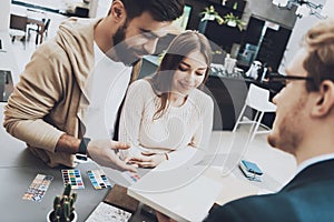 Manager sits at table with customers and discusses