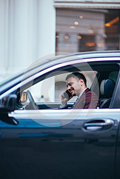 A manager sitting in his limo and discussing and planning his business movies, while applying a lot of body language in his