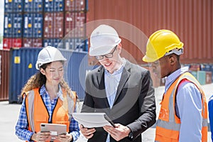 Manager standing in container depo company area