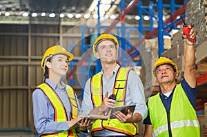 Manager and supervisor taking inventory in warehouse, Foreperson making plans with warehousemen, Workers team working in warehouse