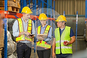 Manager and supervisor taking inventory in warehouse, Foreperson making plans with warehousemen, Workers team working in warehouse