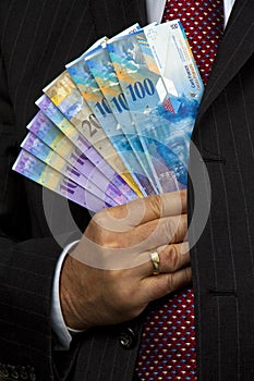 Manager with Swiss franc banknotes
