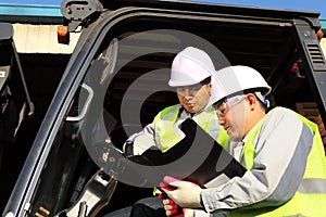 Manager talking to forklift operator photo