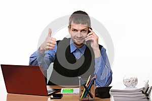 Manager talks on the phone with his thumb up