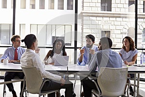 Manager talks to business colleagues at a meeting, close up