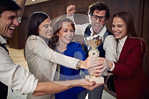 A manager and a team excited about the award at business conference at the hotel. Hotel, business, people