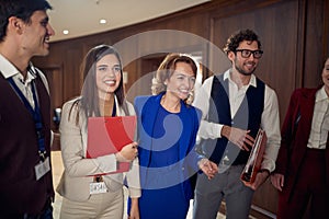 A manager and a team posing for a photo at the hotel hallway. Hotel, business, people