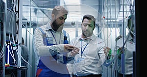 Manager and technician working in a data center