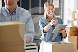 Manager Using Tablet Computer In Distribution Warehouse