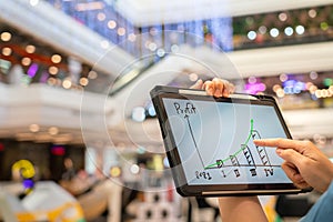 A manager using tablet to see business growth predication graph of 2021. photo