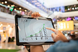 A manager using tablet to see business growth predication graph of 2021. photo