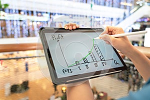 A manager using tablet to see business growth predication graph of 2021. photo