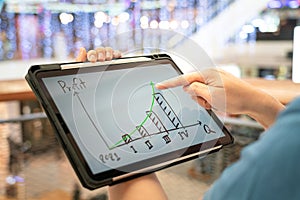 A manager using tablet to see business growth predication graph of 2021. photo
