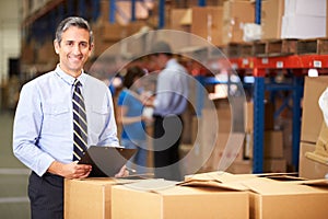 Manager In Warehouse Checking Boxes photo