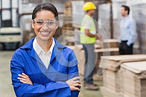 Manager wearing protective mask looking at camera