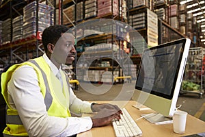 Manager at work in the on-site office of a warehouse