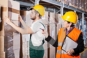 Manager with worker in warehouse