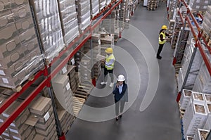 Manager and workers at warehouse, above view. Logistics center