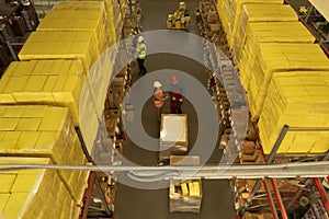 Manager and workers at warehouse, above view. Logistics center