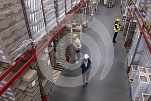 Manager and workers at warehouse, above view. Logistics center