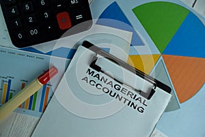 Managerial Accounting write on a paperwork isolated on wooden table photo