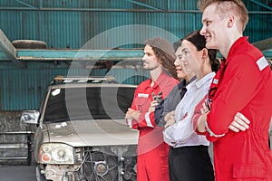 managers and auto mechanic team standing with arms crossed in a repair garage, Car repair and maintenance concepts