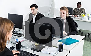 Managers with laptops working in office