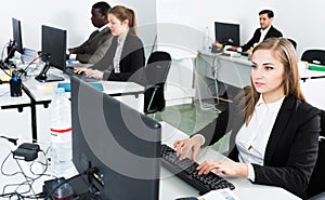 Managers with laptops working in office