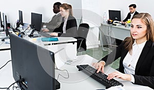 Managers with laptops working in office