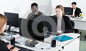 Managers with laptops working in office