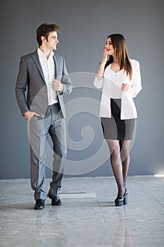 Managers man and woman talking to each other against a office background