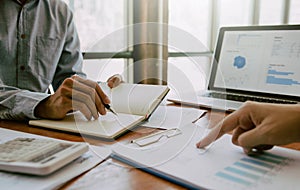 Managers are using tablets to analyze sales cost reports and explain summary reports to employees calculate and record summary