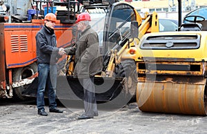 Managers of works in hard hats shaking hands