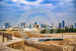 Manama skyline behind ancient Bahrain Fort